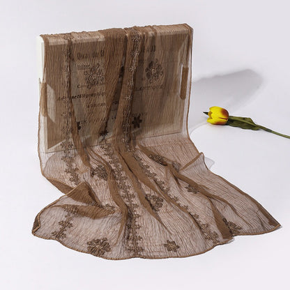 Scarvii lightweight scarf folded to show layered blossom stitch embroidery