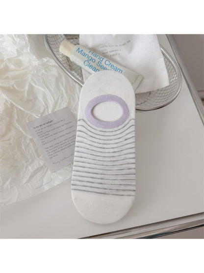 Rufia striped low cut liner socks paired with sneakers on wooden floor