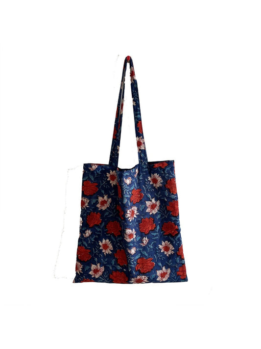 Blue floral shoulder tote bag with double handles on white background
