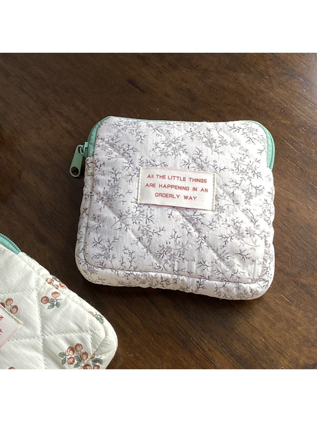 Cosbai cartoon print mini storage pouch showing zipper pull and fabric texture