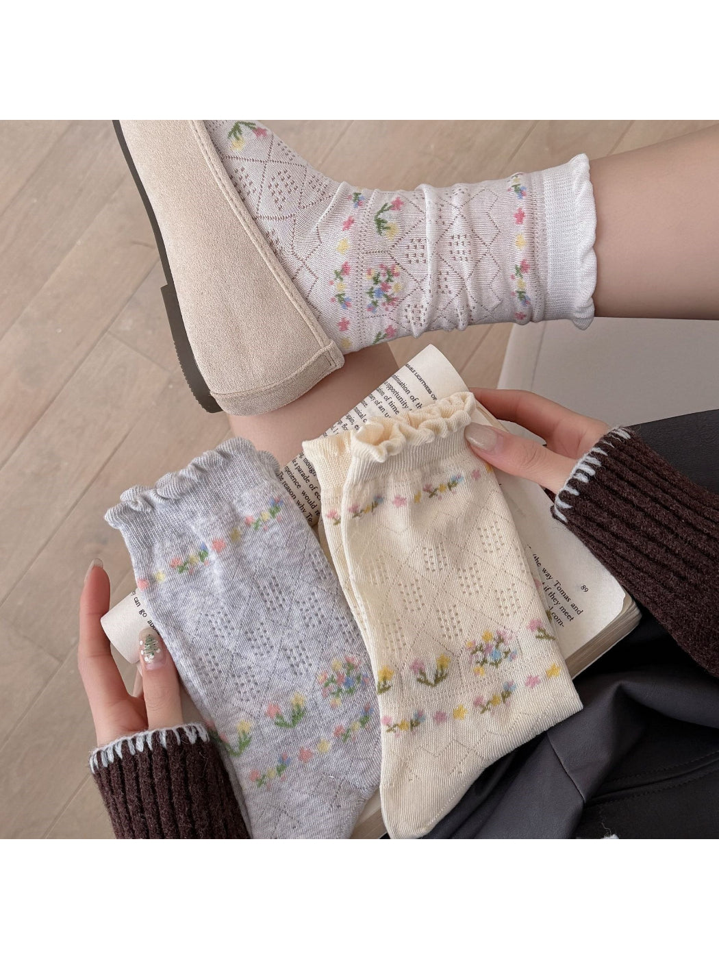 Pair of Rufia floral lace ankle socks displayed flat showing intricate lace pattern