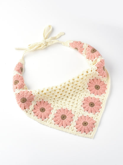 Model wearing crochet hairband with sunflower and mushroom accents