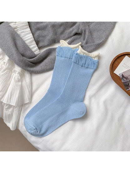 Rufia beige crew socks with ruffle detail displayed on a white background