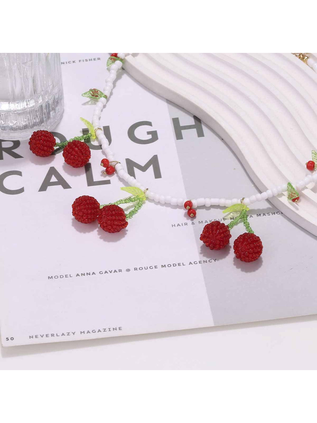 Neckit cherry pendant necklace with white beads shown on a model's neck