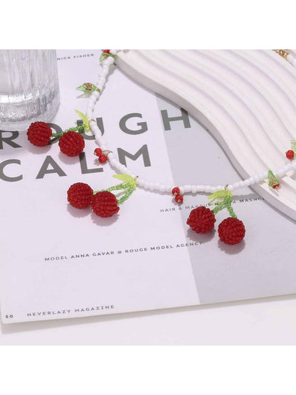 Neckit cherry pendant necklace with white beads shown on a model's neck