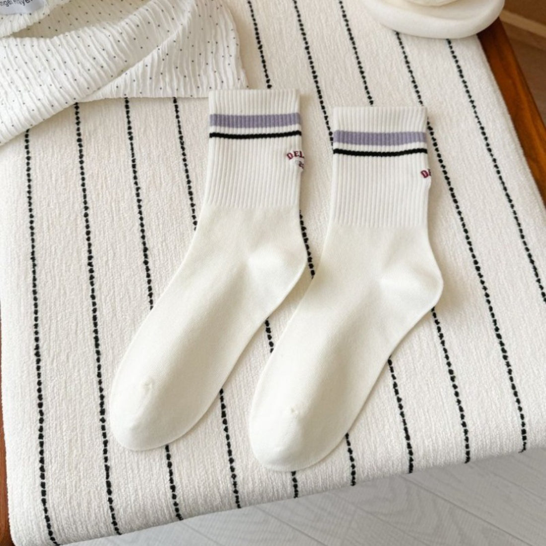Pair of Rufia Retro Stripe Letter Crew Socks laid flat with visible colorful stripes and letters
