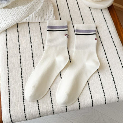 Pair of Rufia Retro Stripe Letter Crew Socks laid flat with visible colorful stripes and letters