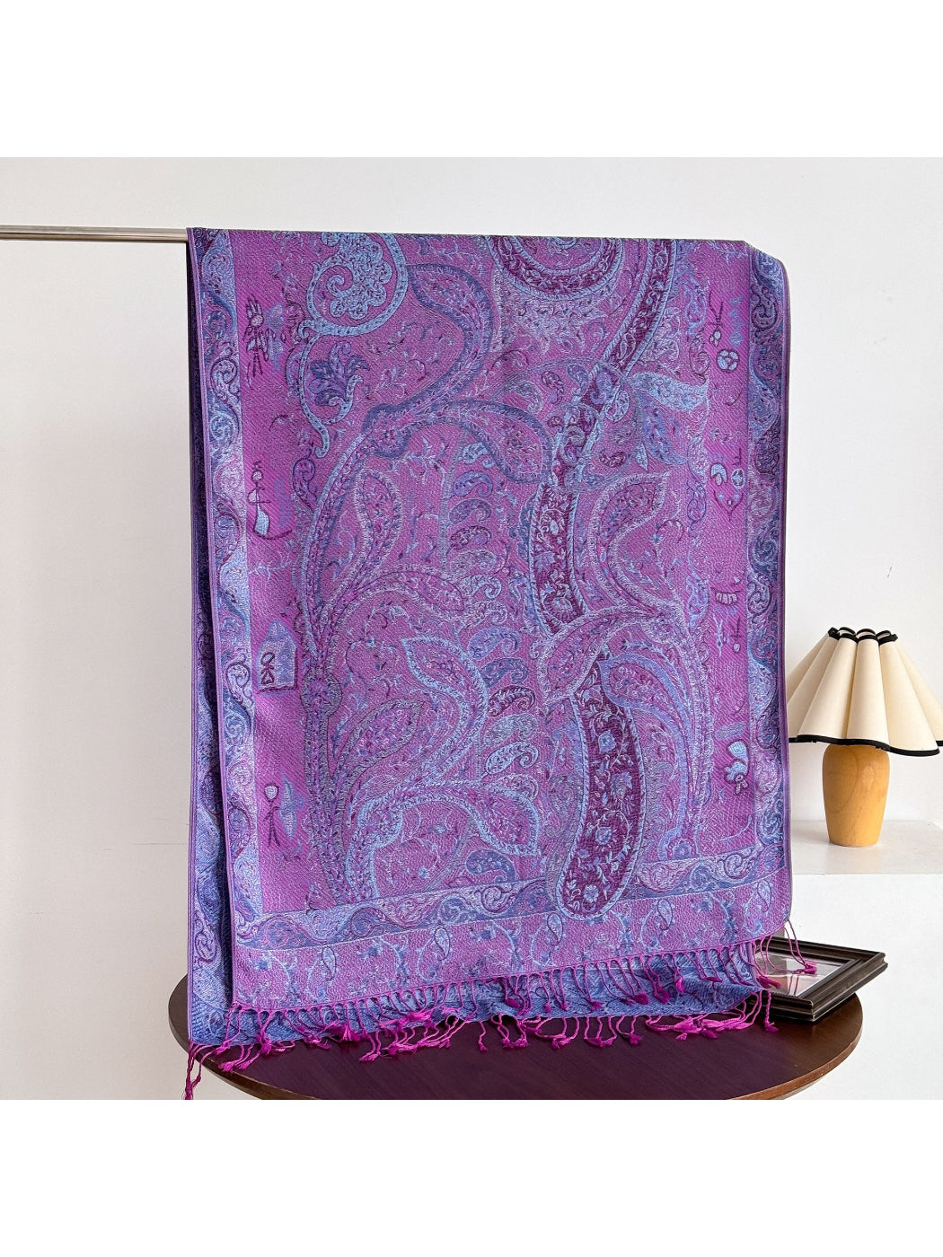 Bohemian paisley shawl with fringed edges folded on a table