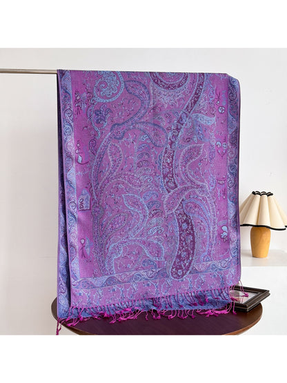 Bohemian paisley shawl with fringed edges folded on a table