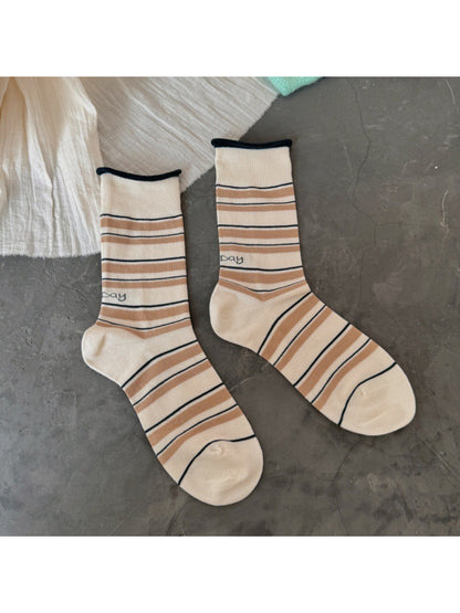 Pair of Rufia Classic Fine Stripe Crew Socks displayed on wooden surface