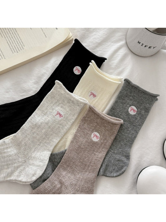 Pair of Rufia casual bow knit socks in light beige color displayed flat