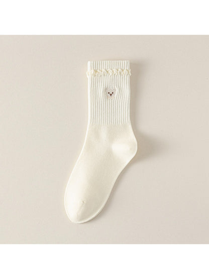 Side view of Rufia beige ribbed socks highlighting teddy cuff