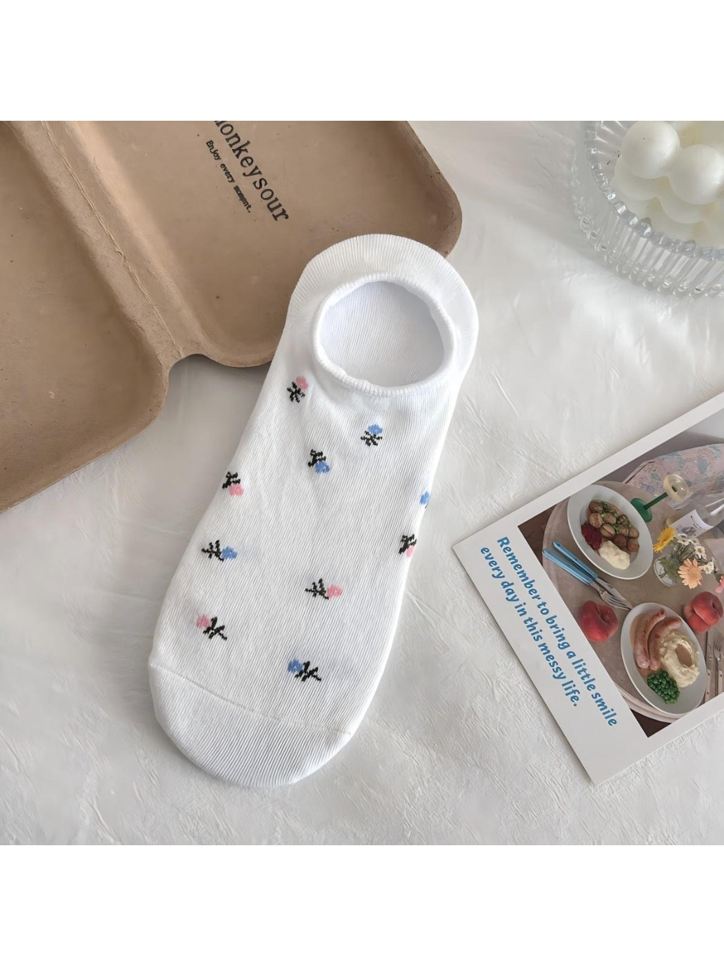 Top view of Rufia Everyday Bloom no show socks displaying colorful flower prints