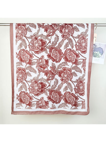Scarvii floral wrap scarf draped over shoulders highlighting large flower motifs