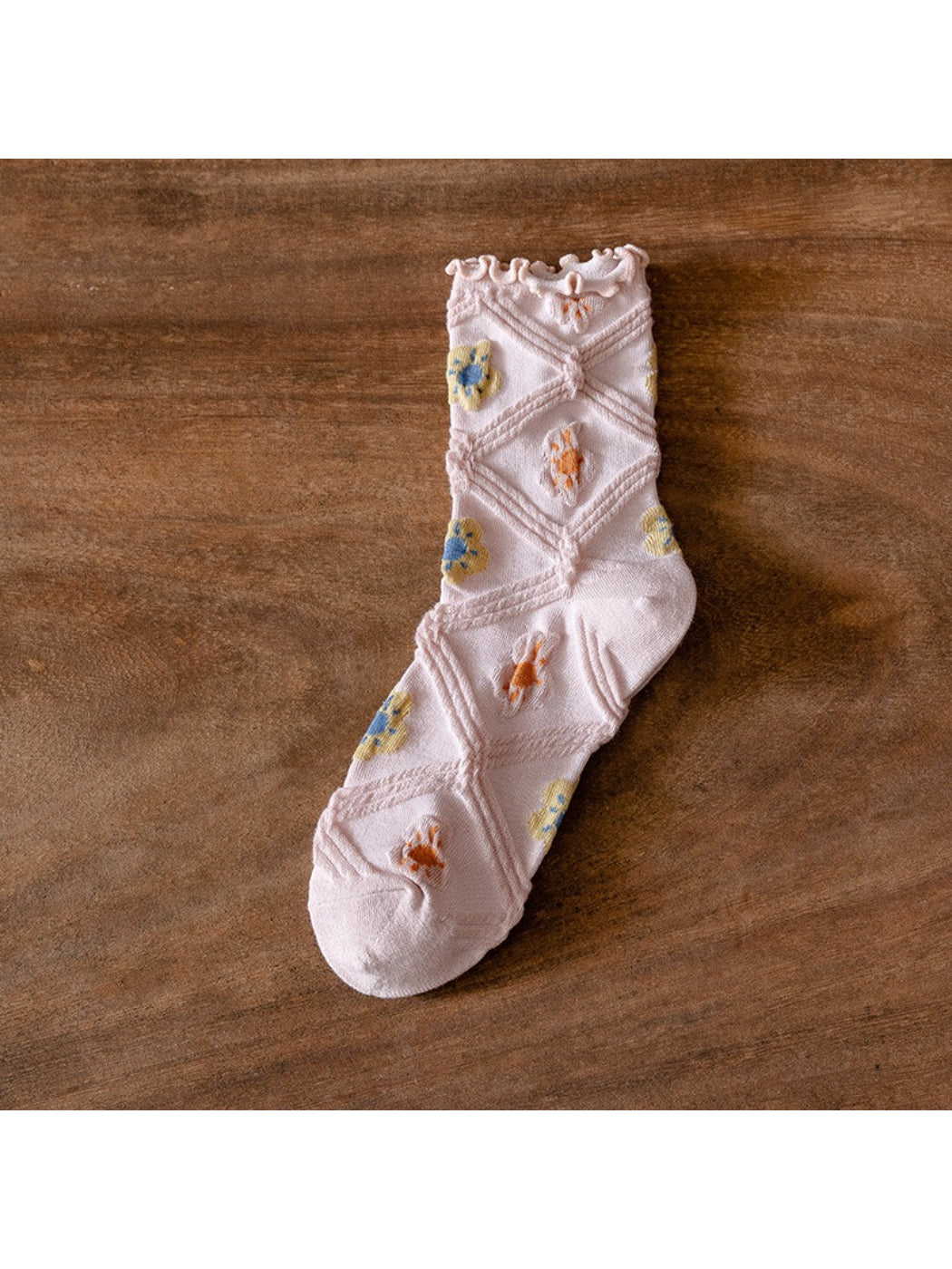 Close-up of Rufia crew socks showing delicate floral mesh pattern on soft fabric