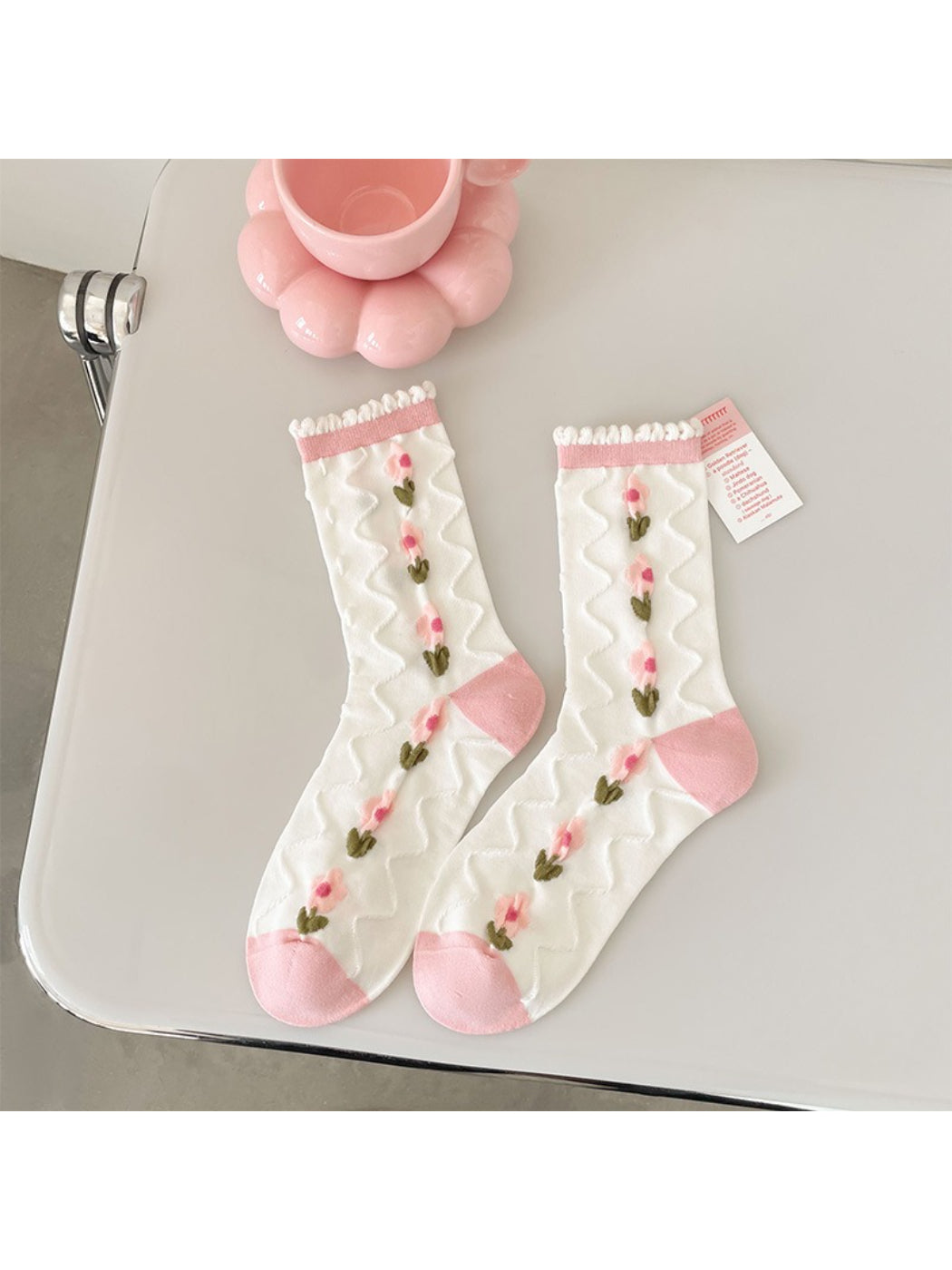 Model wearing Rufia pink floral ribbed crew socks with casual shoes and jeans