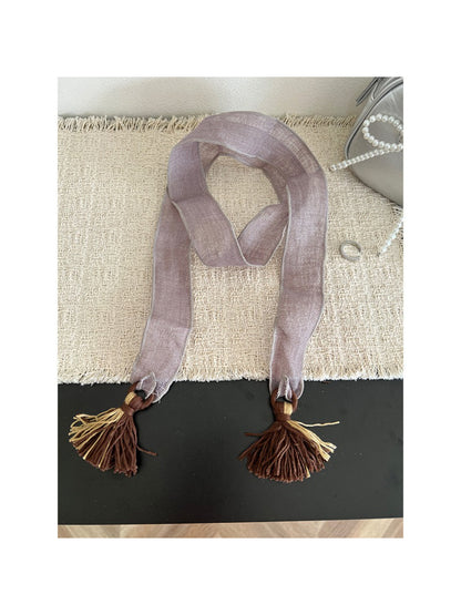 Scarvii boho skinny scarf folded to highlight fabric texture and tassels