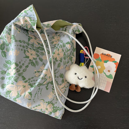 Model carrying Cosbai Soft Bloom floral print shoulder tote bag on shoulder