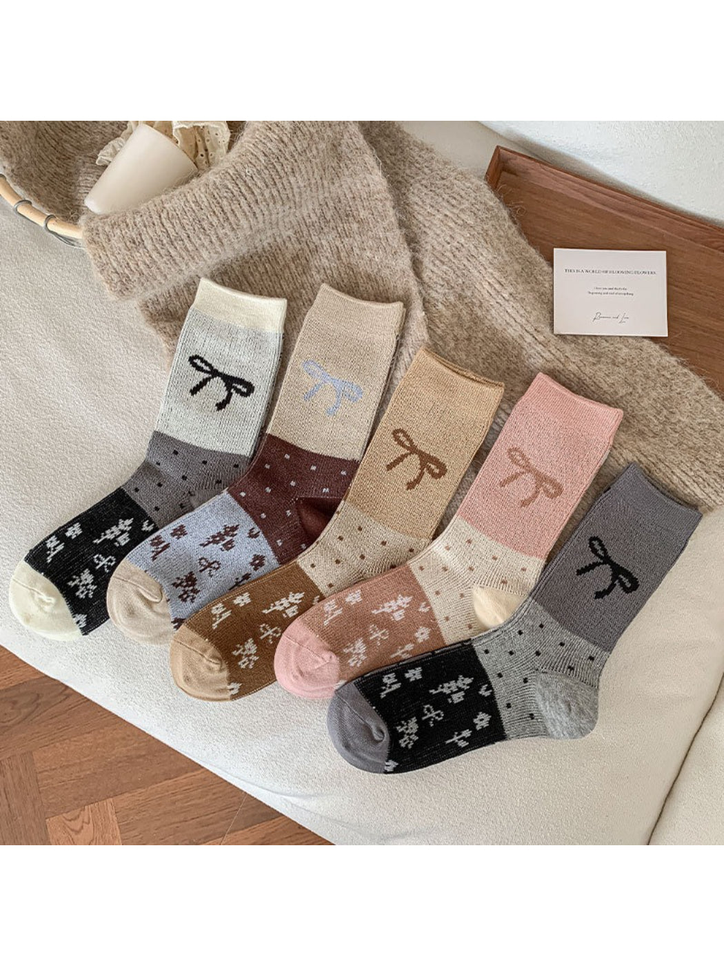 Pair of Rufia playful bow detail crew socks in soft pastel pink laid flat