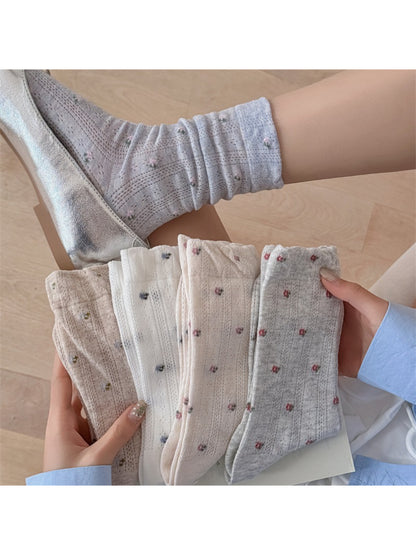 Pair of Rufia soft ditsy floral crew socks in pastel colors displayed flat