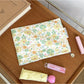 Cosbai Candy Check Makeup Bag with soft pastel check pattern on a plain surface