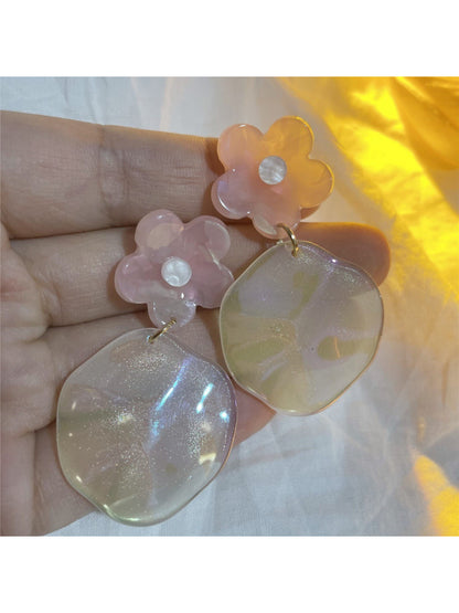 Glossy floral drop earrings with pink and white petals on a white background