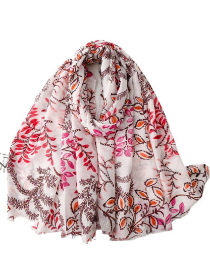 Model wearing Scarvii Botanical Vine lightweight scarf draped around neck outdoors