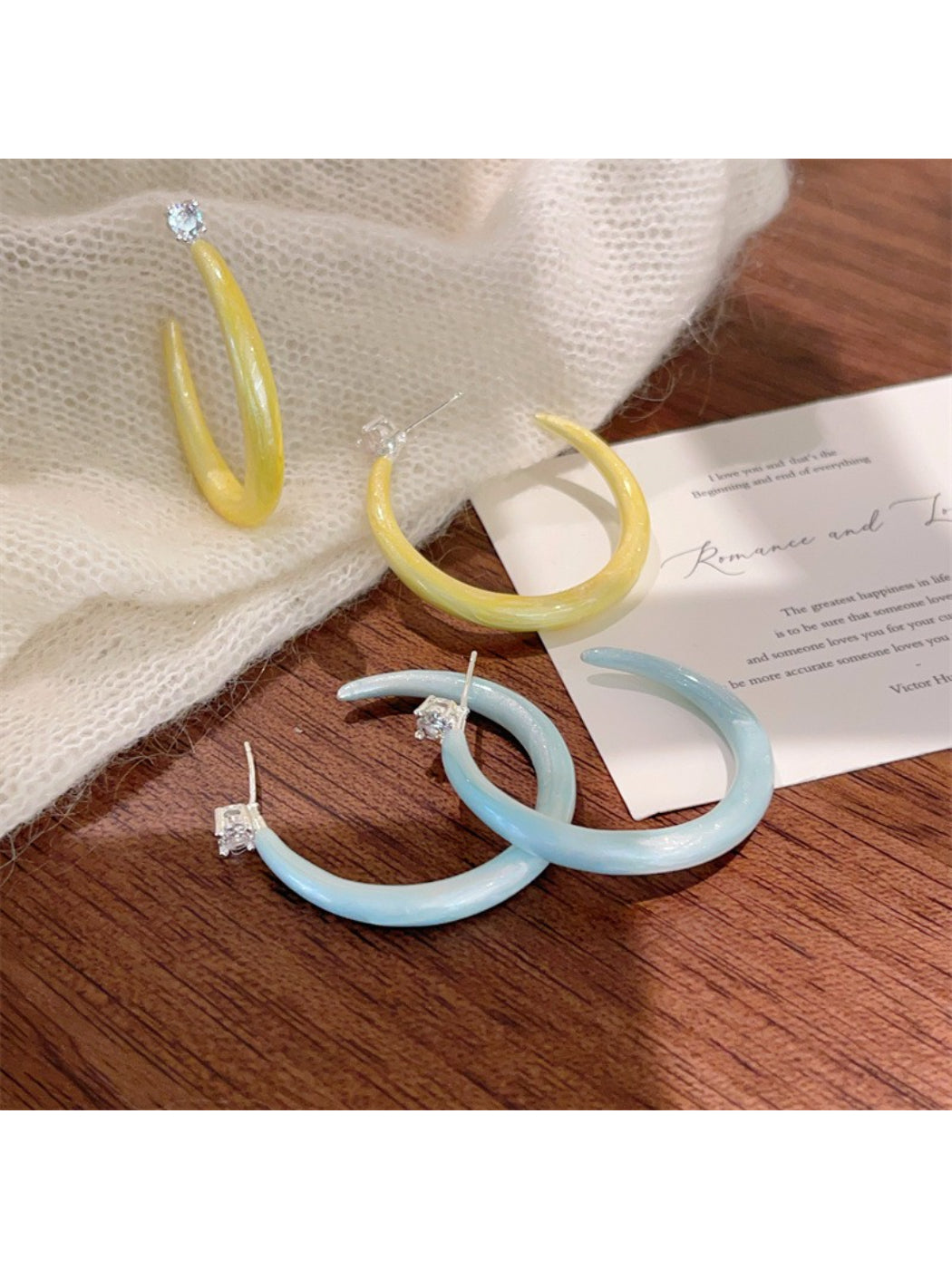 Glossy color hoop earrings displayed on a white background