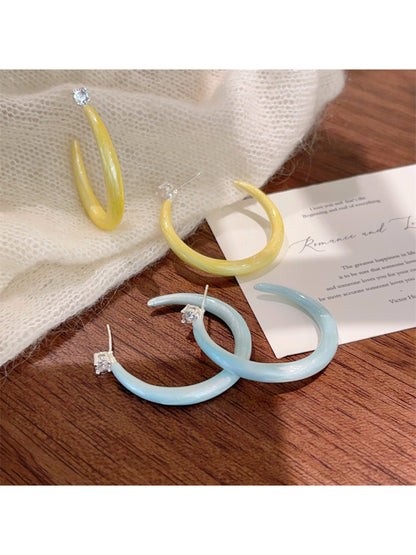 Glossy color hoop earrings displayed on a white background