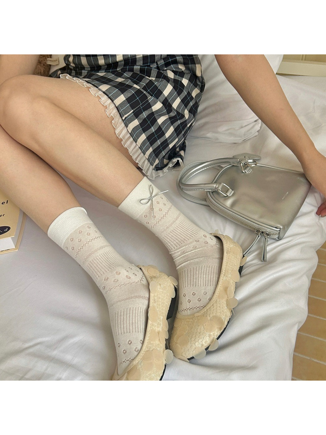 Pair of Rufia socks showing bow detail and textured fabric