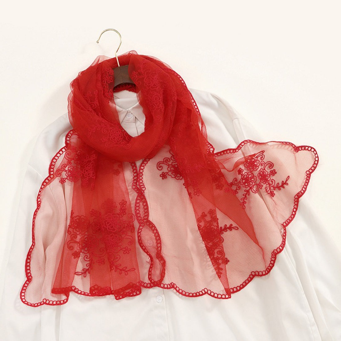 Detailed view of golden baroque embroidery on transparent Scarvii scarf