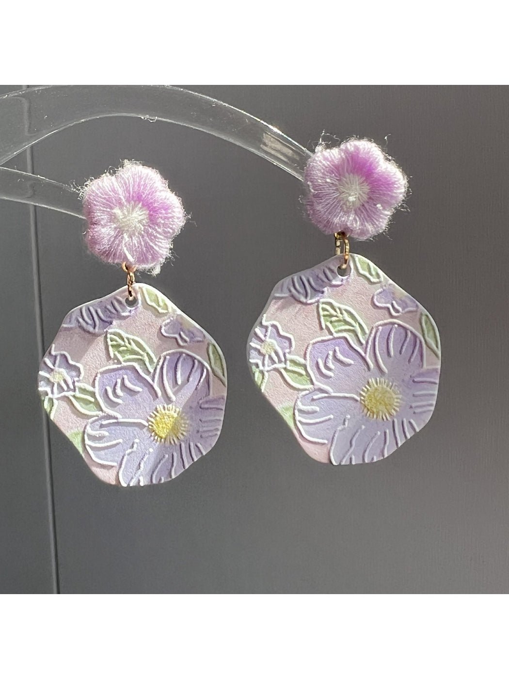 Earwish Purple Bloom Drop Earrings shown hanging from a jewelry stand