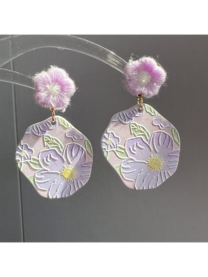 Earwish Purple Bloom Drop Earrings shown hanging from a jewelry stand