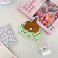 Cosbai mini polka dot pouch bag displayed with a hand holding it