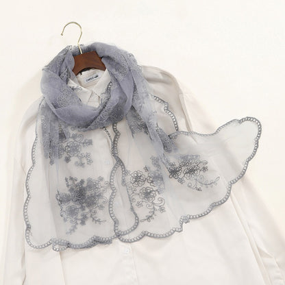 Scarvii sheer scarf draped over shoulders showing elegant embroidery design
