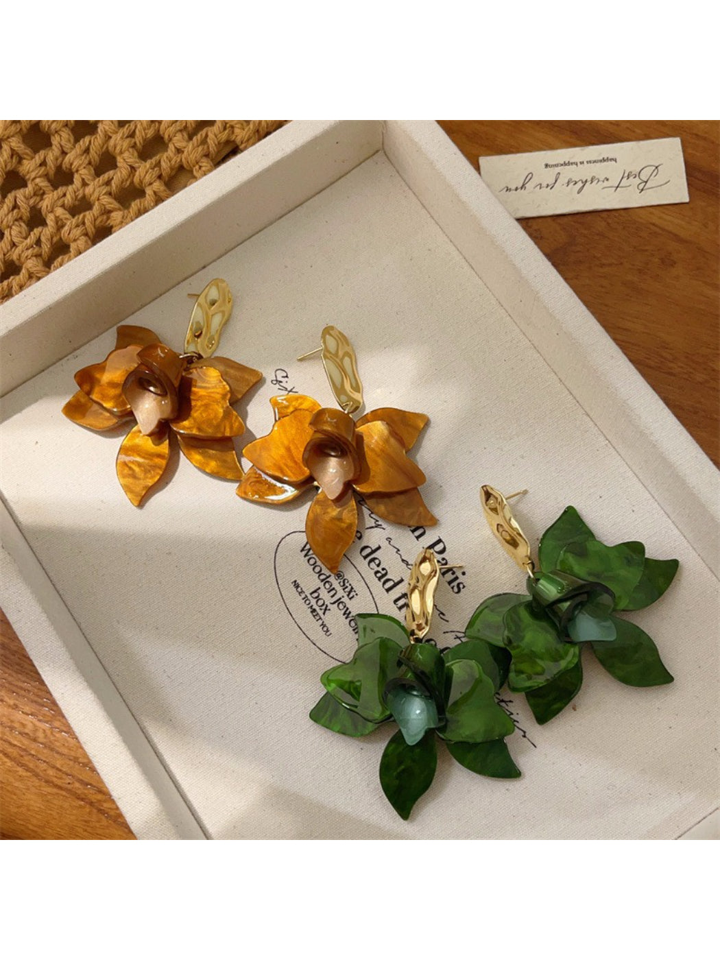 Close-up of Earwish artistic floral drop earrings with intricate flower design