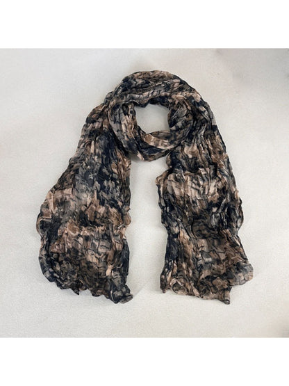 Model wearing Scarvii scarf with textured painterly print styled with casual outfit