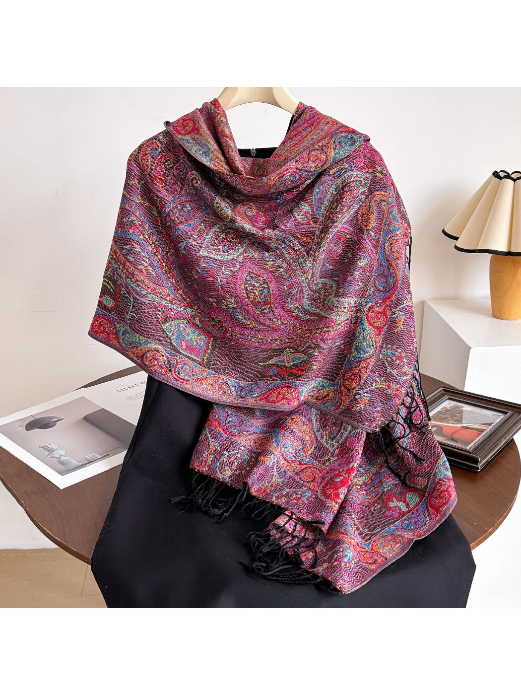 Bohemian paisley fringe shawl draped over a wooden chair