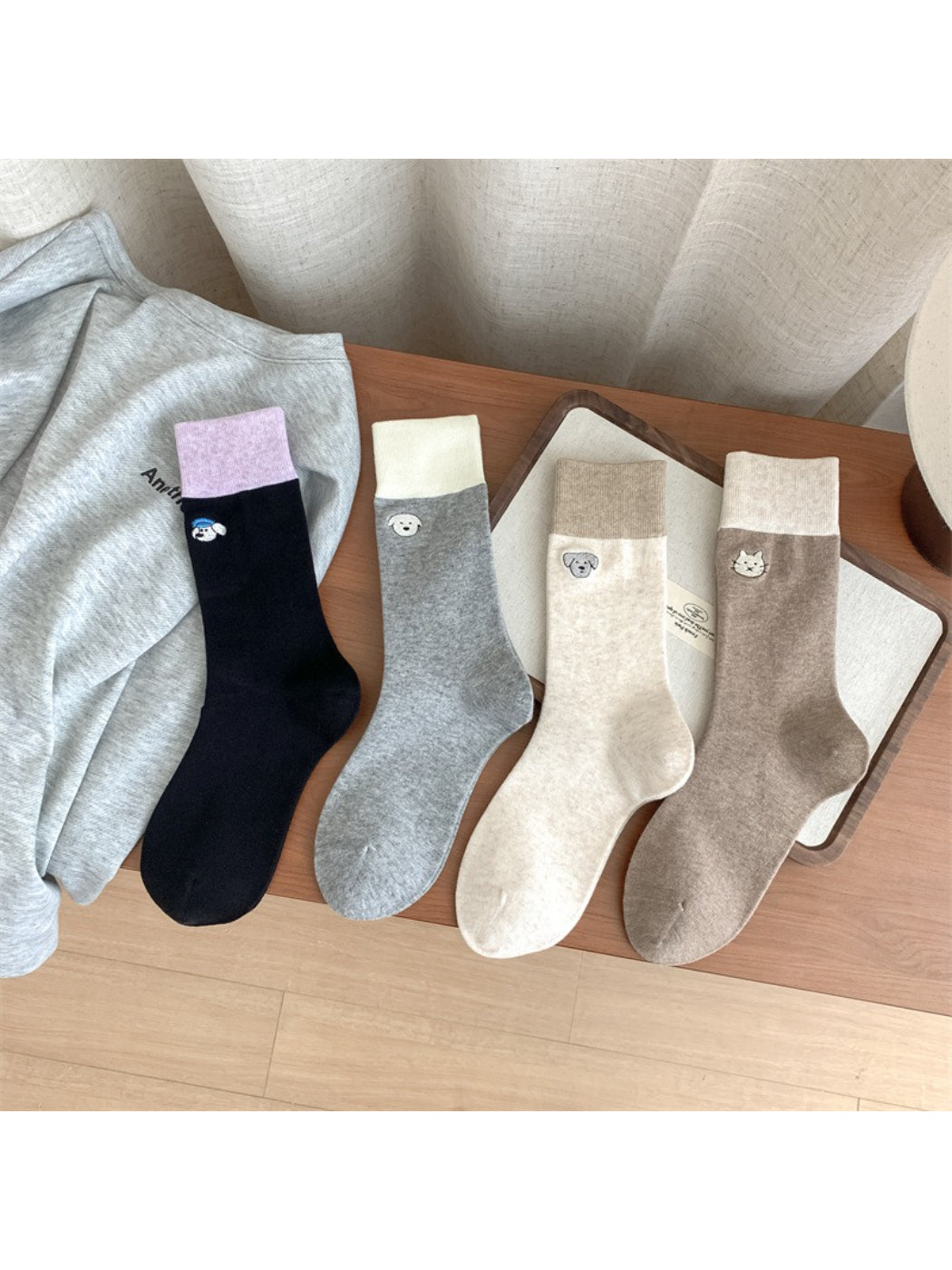 Close-up of Rufia soft crew sock showing detailed animal embroidery on ankle