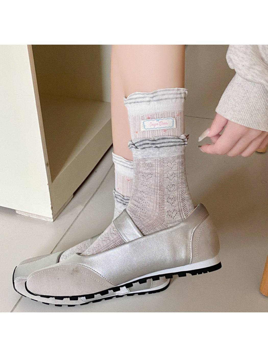 Rufia socks worn on feet highlighting the ribbon and check design