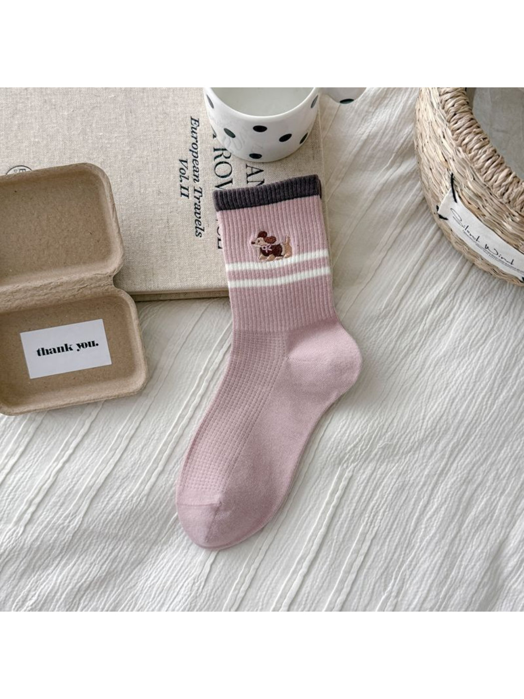 Rufia crew socks with dog embroidery worn on feet showing stripes