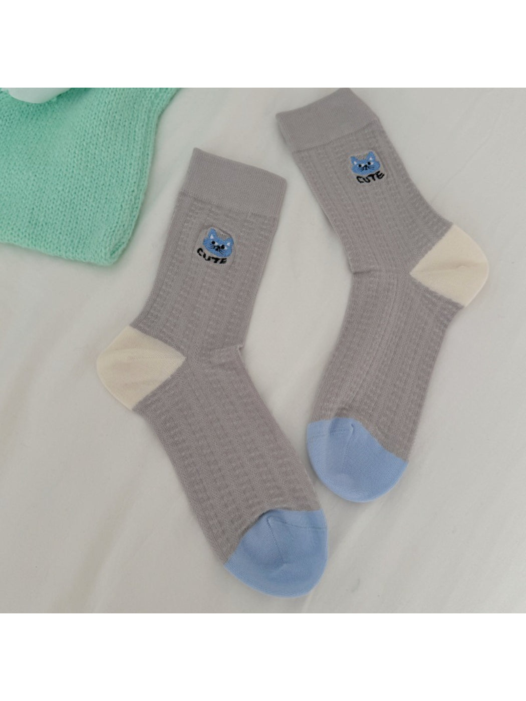 Rufia soft cat knit crew socks displayed on wooden surface