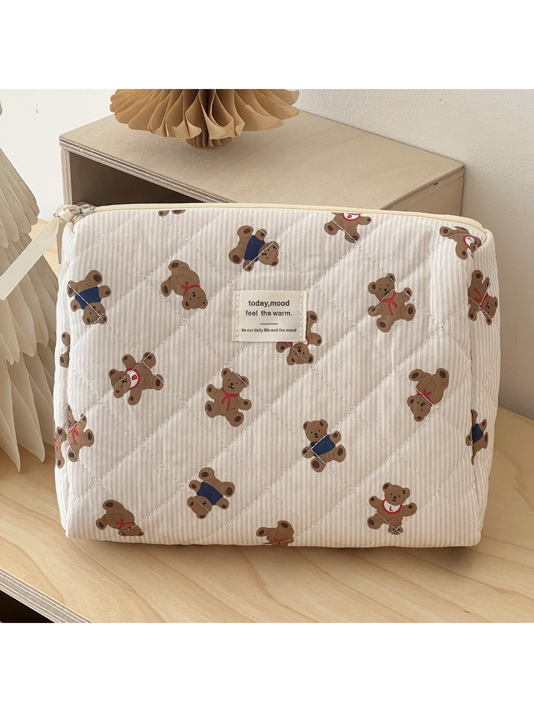 Open teddy bear makeup bag displaying organized for cosmetics