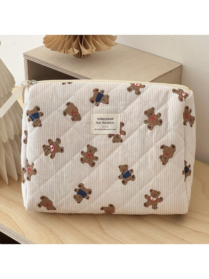 Open teddy bear makeup bag displaying organized for cosmetics