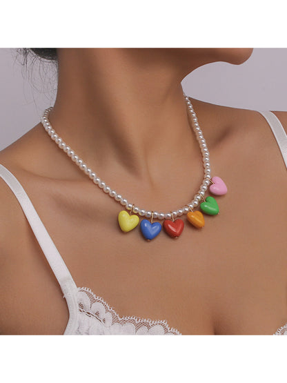 Close-up of colourful heart charm on Neckit necklace with silver chain