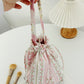 Cosbai soft floral drawstring handbag shown with handle extended