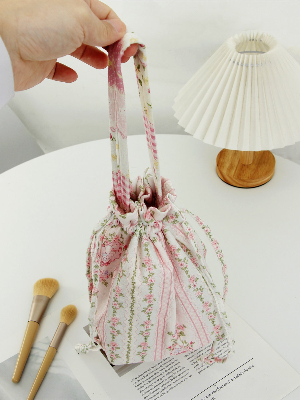 Cosbai soft floral drawstring handbag shown with handle extended