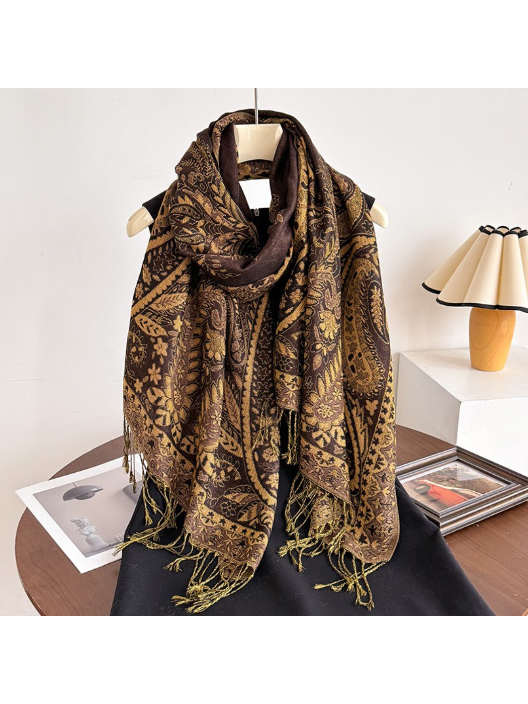 Scarf wrapped around model’s neck with tassels hanging down