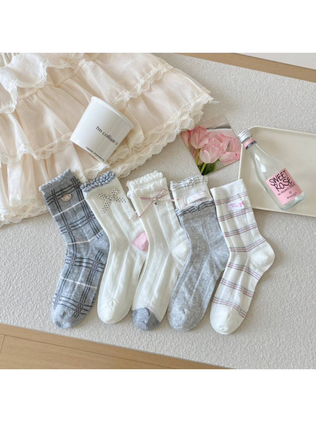 Pair of Rufia cute ribbon and check crew socks in pastel colors displayed flat