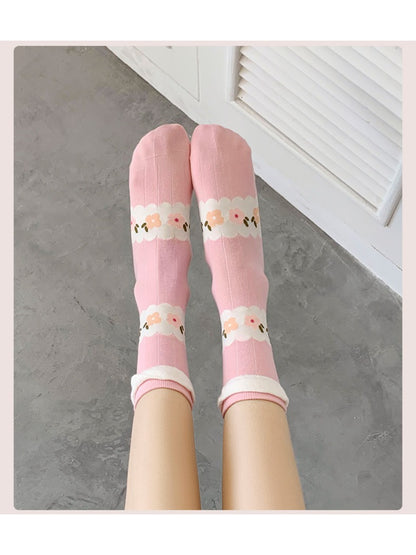 Rufia pink floral ribbed crew socks styled with a summer outfit on a wooden floor